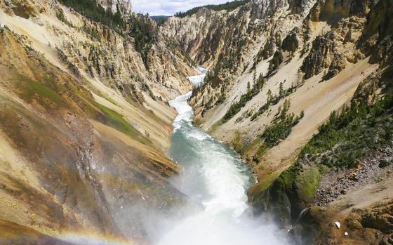 This June 17, 2017 file photo shows the Yellowstone River flowing through the Grand Canyon in Yellowstone National Park, Wyo. Yellowstone National Park is about to turn 150 years old. President Ulysses S. Grant signed the Yellowstone National Park Protection Act in 1872, setting aside one of the world's largest nearly intact ecosystems.