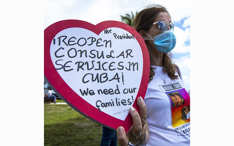 Marietta Medialdea holds a heart-shaped candy box with a message to President Joe Biden to “reopen the consulate in Cuba” in Miami, Fla., on March 14, 2021. 