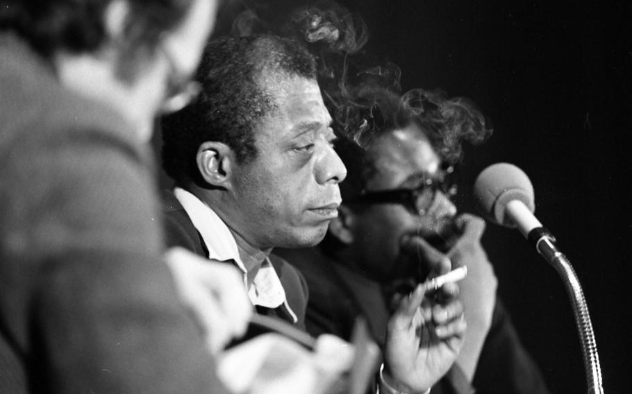 Author James Baldwin smokes as he listens to a question from the audience at the Liederhalle in Stuttgart, Feb. 16, 1973.