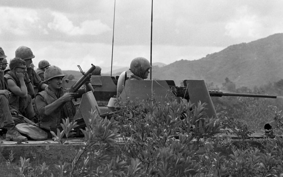 Soldiers fire from their vehicle.