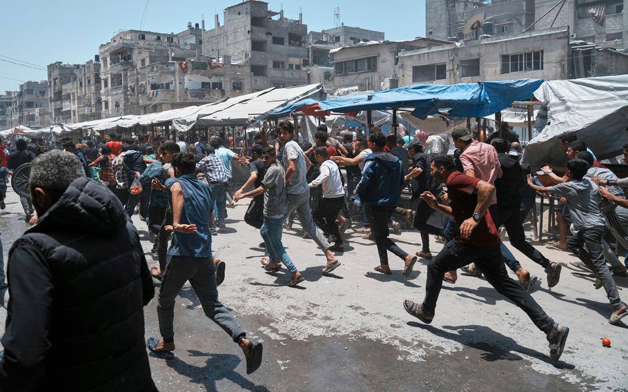 A crowd scatters,