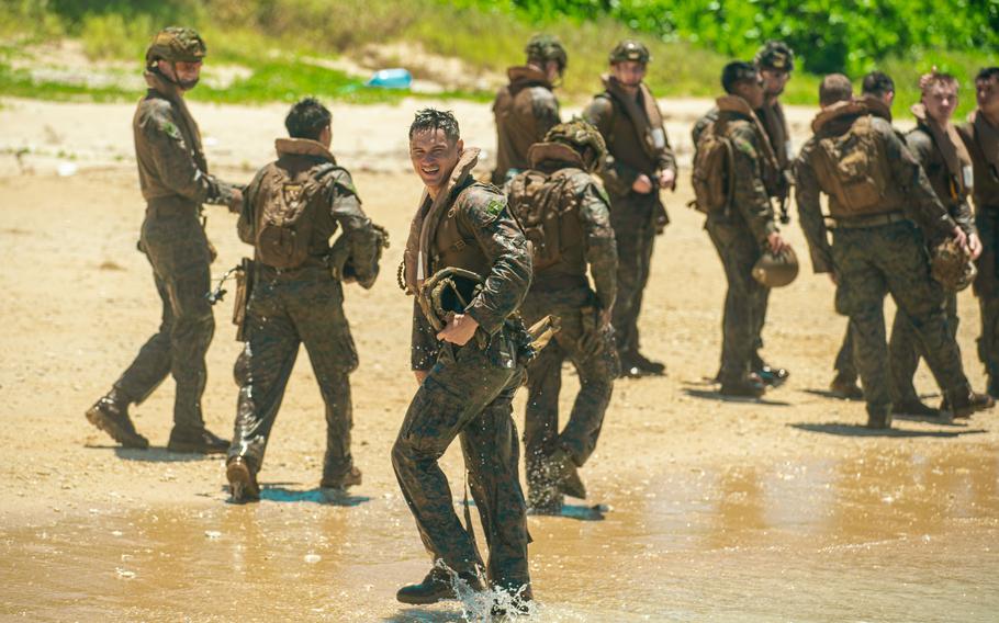 Marines of Alpha Company, Battalion Landing Team 1/5, walk back on shore after vehicle egress training from Amphibious Combat Vehicles at White Beach Naval Facility, Okinawa, Japan, June 24, 2024. 