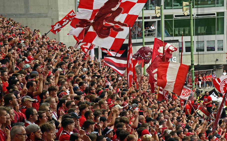 Supporters wave flags and cheer during an FC Kaiserslautern soccer match at Fritz Walter Stadium.