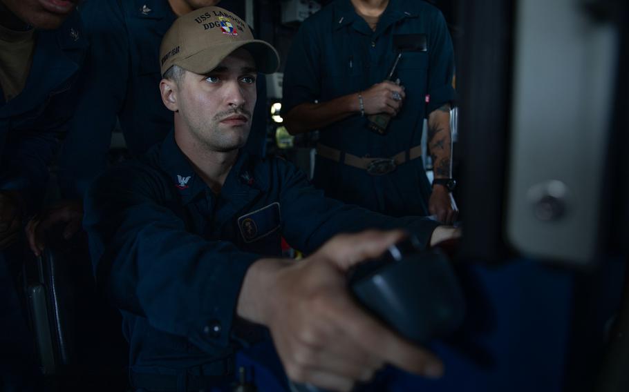 A Navy Fire Controlman operates a 5-inch lightweight gun during a pre-action calibration firing aboard the Arliegh Burke-class guided-missile destroyer USS Laboon in the Red Sea, March 26, 2024. A warship — part of a U.S.-led coalition protecting shipping in the Mideast — intercepted an anti-ship ballistic missile fired over the Gulf of Aden, the American military said.