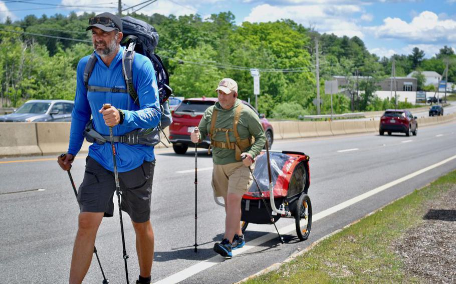 Coleman "Rocky" KInzer, left, and Justin LeHew walk along Route 20 in Charlton, Mass. They are just starting out on a journey by foot along Route 20 from Boston to Oregon to raise awareness for U.S. service personnel killed overseas and considered missing in action.