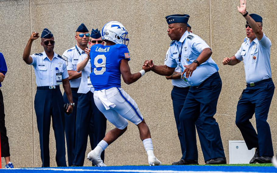 Air Force’s Zac Larrier celebrates with Lt. Gen. Richard M. Clark, Air Force Academy Superintendent, after scoring a touchdown against Robert Morris University on Sept. 2, 2023, during a game in Falcon Stadium at the U.S. Air Force Academy. Clark played linebacker at Air Force in the 1980s. 