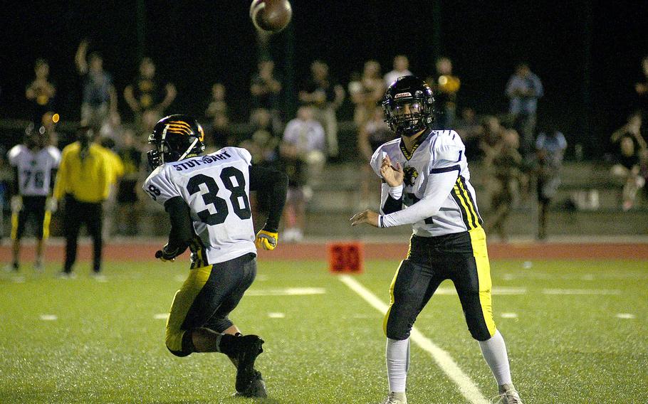 Stuttgart quarterback Ty Jones throws into the flat after faking the handoff to teammate Jack Gruver during the Panthers' 14-9 loss to the Royals at Ramstein High School on Ramstein Air Base, Germany.