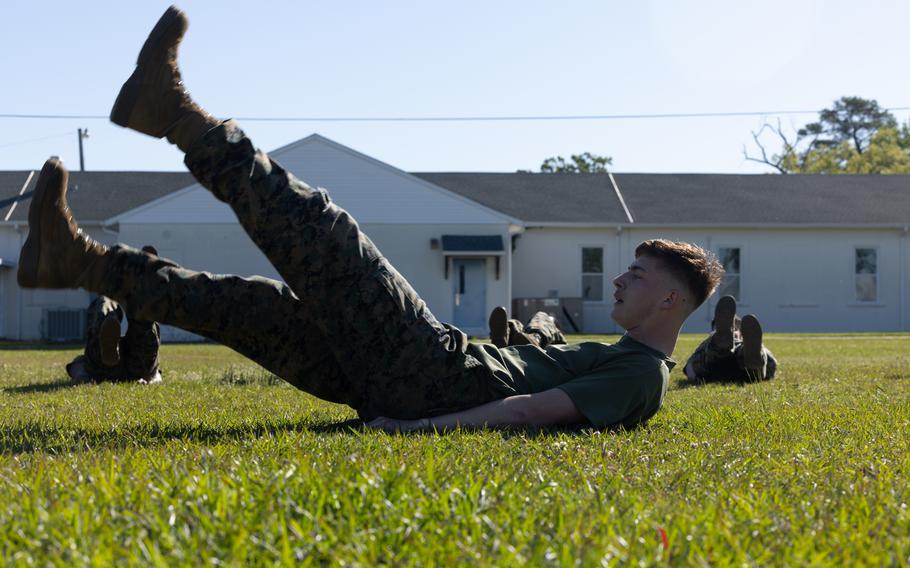 A Marine leads a flutter-kick exercise