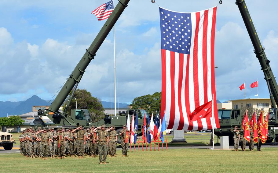 Marines stand in formation on Dewey Square at Marine Corps Base Hawaii during a ceremony March 3, 2022, redesignating 3rd Marine Regiment as 3rd Marine Littoral Regiment.