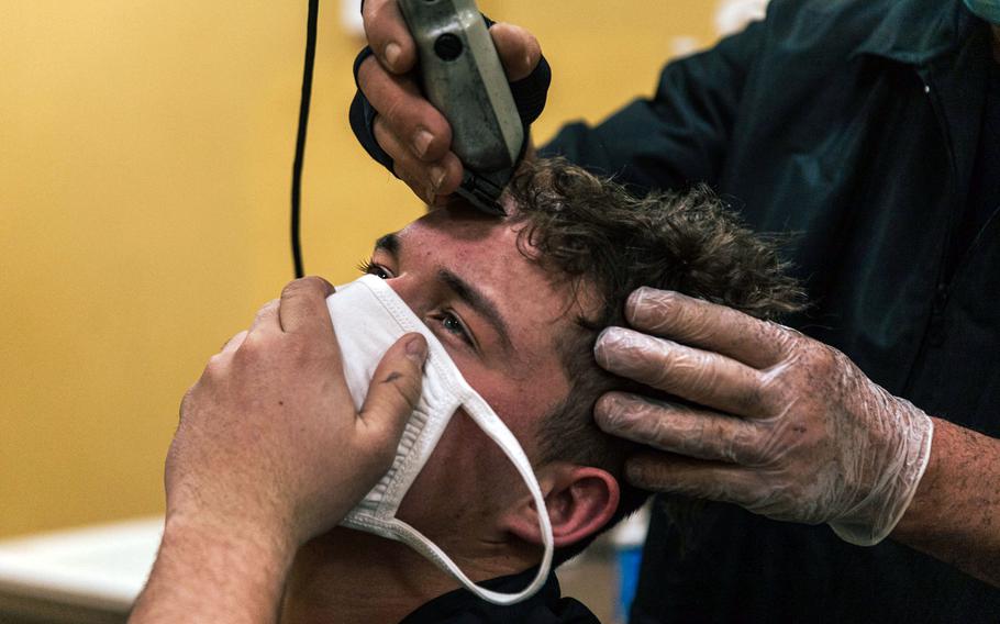 A Marine Corps recruit gets his hair cut during receiving at Marine Corps Recruit Depot San Diego, Feb. 7, 2022. 