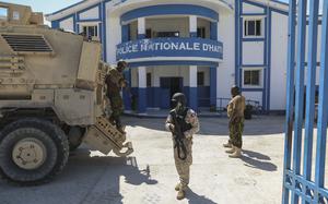 FILE - Haitian and Kenyan police who are part of a UN-backed multinational force stand at a police station in Pont-Sonde, Haiti, Oct. 7, 2024, days after a gang attacked the town. (AP Photo/Odelyn Joseph, File)