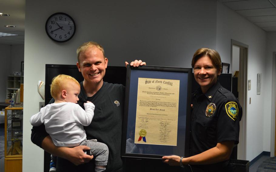 The N.C. National Guard involuntarily activated Sgt. Brett Foust, left, with the Asheville Police Department several times in 2020 and 2021, his lawyer said in federal court documents. When he returned to the police force, Foust was reportedly denied training opportunities and nearly declared unfit for duty unless he passed multiple fitness exams.