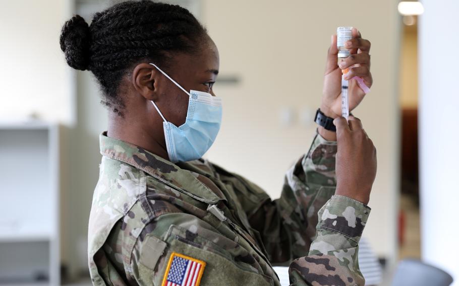 Pfc. Shaniah Edwards prepares to administer a Moderna COVID-19 vaccine to soldiers and airmen in the Virgin Islands, Feb. 12, 2021.
