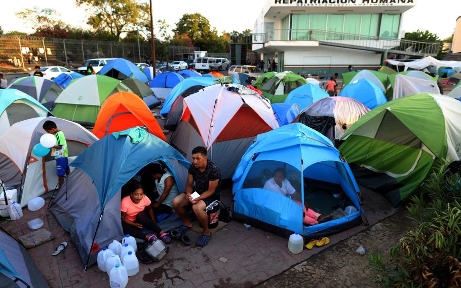 Migrants from Central America and Mexico await the outcome of their U.S. immigration court cases in a tent encampment near the Gateway International Bridge at the U.S.-Mexico border in Matamoros, Tamaulipas, Mexico, on Oct. 1, 2019. 
