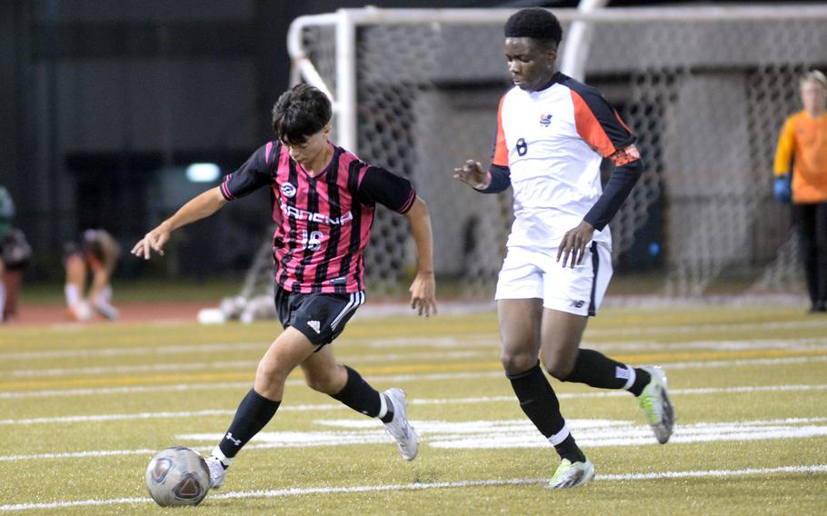 Kadena's Skylar Dluzeski and Nile C. Kinnick's Leon Awesso chase the ball during Friday's DODEA interdistrict boys socceer match. The Panthers prevailed 2-0 in a rematch of last spring's Far East Division I final, won by the Red Devils at Kinnick 3-2.