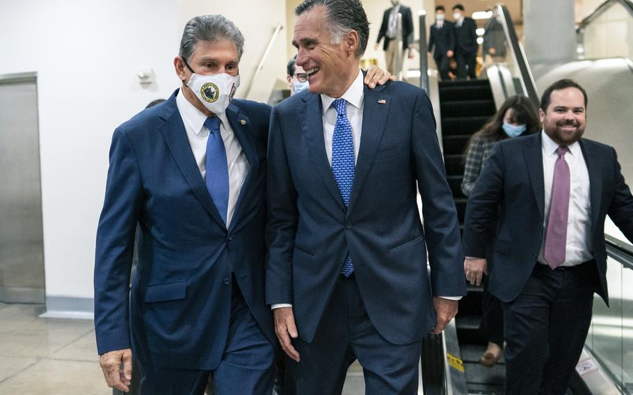 Sen. Joe Manchin, D-WVa., left and Sen. Mitt Romney, R-Utah, walk together on Capitol Hill in Washington, Thursday, Nov. 4, 2021. 