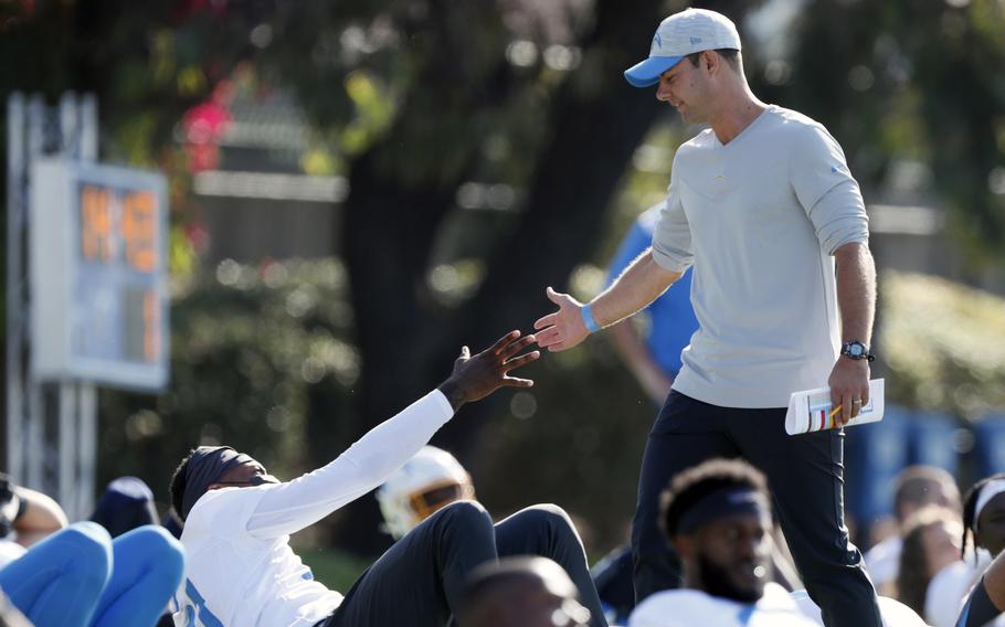 Los Angeles Chargers head coach Brandon Staley greets wide receiver Mike Williams during practice at the NFL football team's training camp July 28 in Costa Mesa, Calif. As workers return to the office, friends reunite and more church services shift from Zoom to in person, this exact question is befuddling growing numbers of people: to shake or not to shake. 