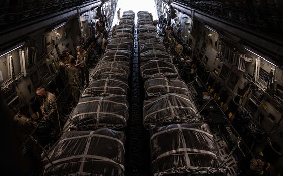U.S. Airmen and Soldiers secure 40 bundles of humanitarian aid on a C-17 Globemaster III assigned to the Air Mobility Command, at an undisclosed location within the U.S. Central Command area of responsibility, March 29, 2024. Delivering humanitarian aid through an airdrop ensures the aid is received by civilians most in need without delay for communities which may be difficult to reach on the ground due to geography. (U.S. Air Force photo)