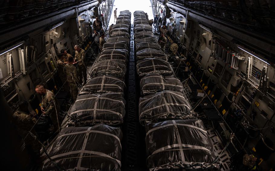 U.S. airmen and soldiers secure 40 bundles of humanitarian aid on a C-17 Globemaster III assigned to the Air Mobility Command, at an undisclosed location within the U.S. Central Command area of responsibility, March 29, 2024. 
