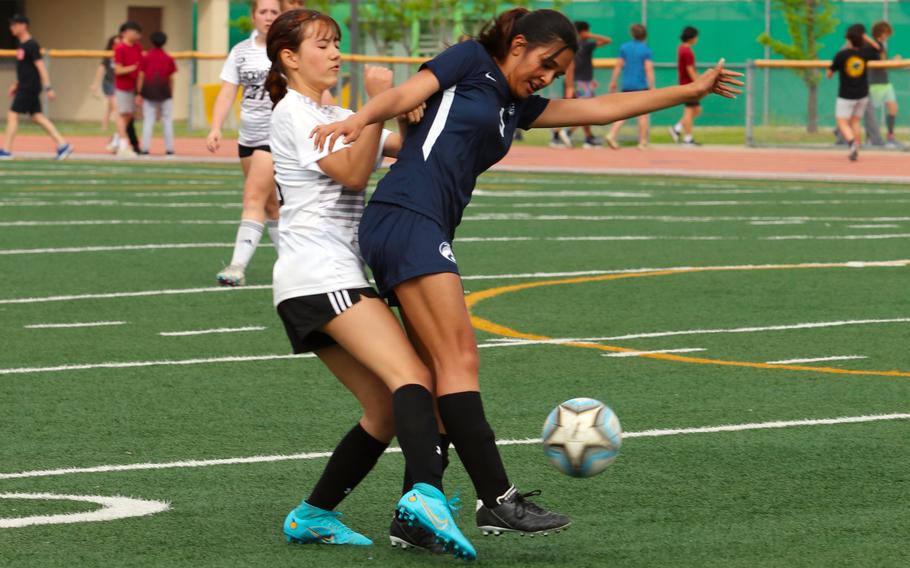 Humphreys' Isabel Maloney and Osan's Camrynn Tuigamala tussle for the ball during Monday's quarterfinal in the Korea postseason girls soccer tournament. The Blackhawks won 8-5 but later lost to Chadwick 6-2 in the semifinal. Osan remains alive for fifth place, while Humphreys will play for third Saturday.