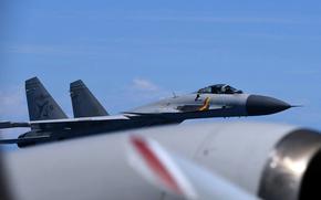 A close up of a fighter jet flying in the air.