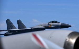 A close up of a fighter jet flying in the air.