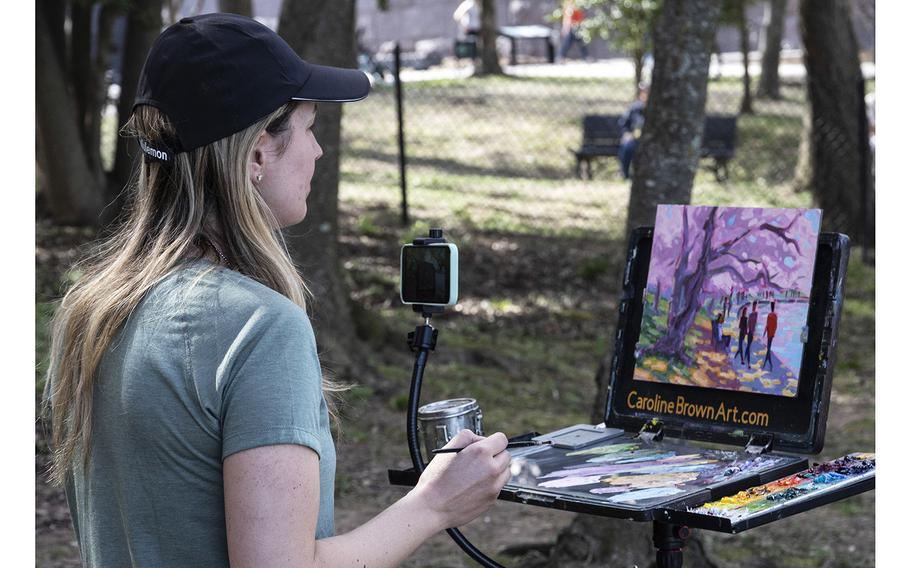 An artist captures the cherry blossoms in Washington, D.C., March 23, 2023.