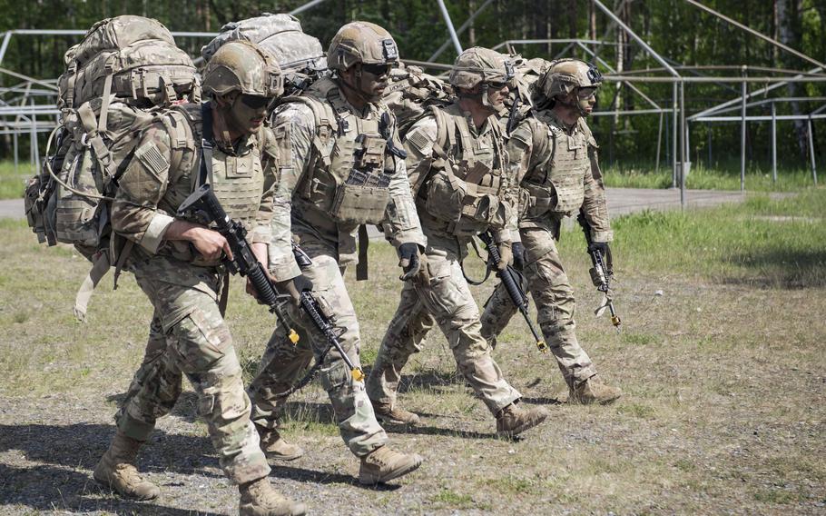 Four soldiers march with their legs in sync.