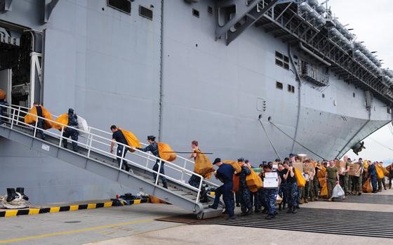 Sailors and Marines move mail onto the amphibious assault ship USS Makin Island during a stop in Singapore, Dec. 12, 2011. 
