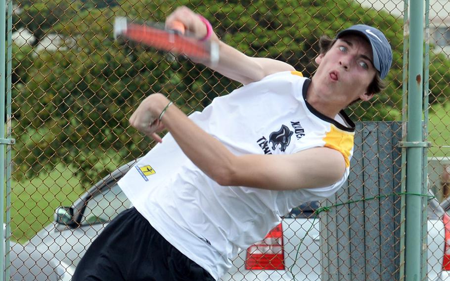 Kadena's Evan Davis serves against Kubasaki's Owen Ruksc during Thursday's Okinawa high school tennis matches. Davis won 8-1, one of only four matches completed before the rest of the 14 were rained out.