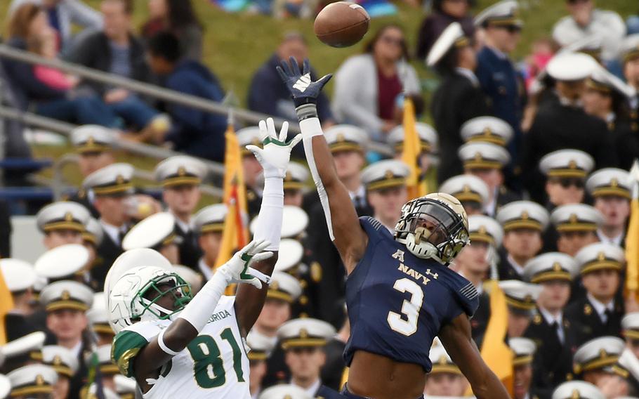 Navy's Cameron Kinley (3) goes up to disrupt a pass to South Florida's Kevin Purlett (81) in the second quarter at Navy-Marine Corps Memorial Stadium in Annapolis, Md., on Saturday, Oct. 19, 2019.