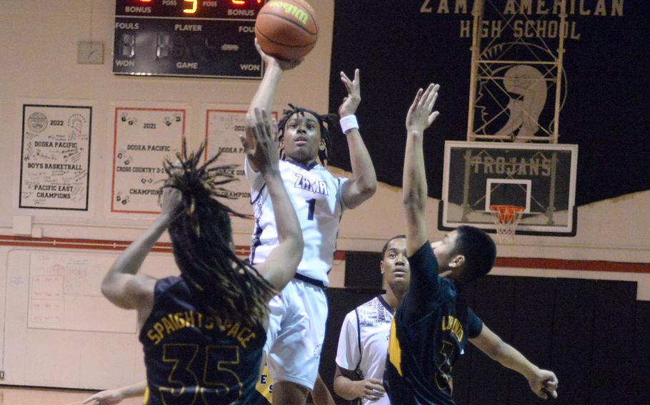 Zama's Ayden Helton shoots over Robert D. Edgren's JeShawn Spaights-Pace and P.J. Lorenzo during Friday's DODEA-Japan boys basketball game. The Trojans won 61-37.