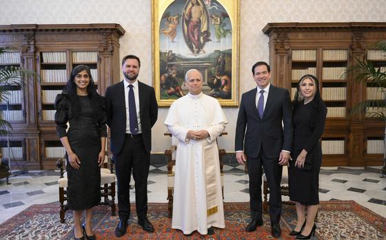 Pope Leo XIV stands for a family photo with Vice President JD Vance, second from left, his wife Usha Vance, Secretary of State Marco Rubio, second from right, and his wife Jeanette Dousdebes Rubio, on the occasion of their meeting at the Vatican, Monday, May 19, 2025. (Vatican Media via AP)