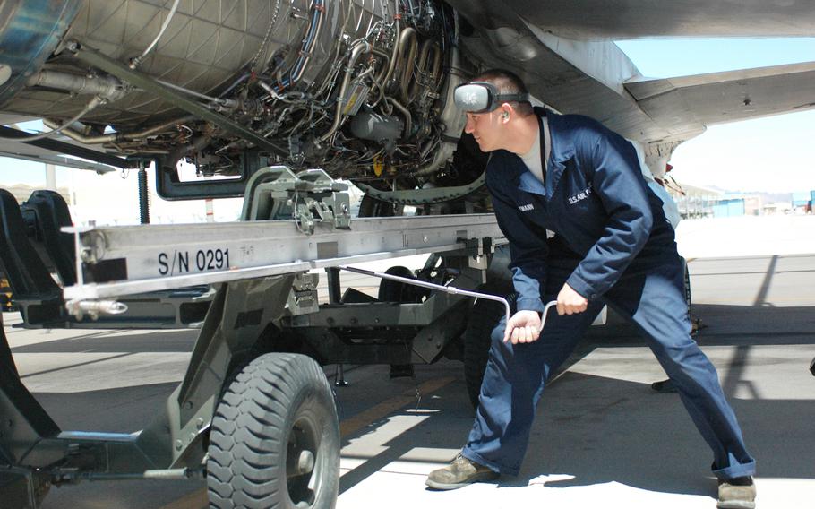 Airman 1st Class Josh Hegemann, an F-16 crew chief, installs an engine on the 162nd Fighter Wing flightline wearing newly issued coveralls in 2009. Airmen working in maintenance and other labor-intensive jobs will soon be able to wear a grey-green, service-issued coverall on the job, the Air Force has said.