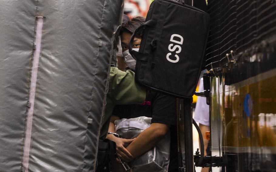 Detained activist Jimmy Sham, center, leaves a prison van to enter the Court of Final Appeal as Hong Kong’s top court hear the activist’s last bid to ask for recognition of his New York-registered same-sex marriage in Hong Kong, on June 28, 2023. Sham partially won his final appeal Tuesday, Sept. 5, 2023, seeking recognition for same-sex marriage registered overseas, in a landmark court ruling that is likely to have a far-reaching impact on the city’s LGBTQ+ community. 