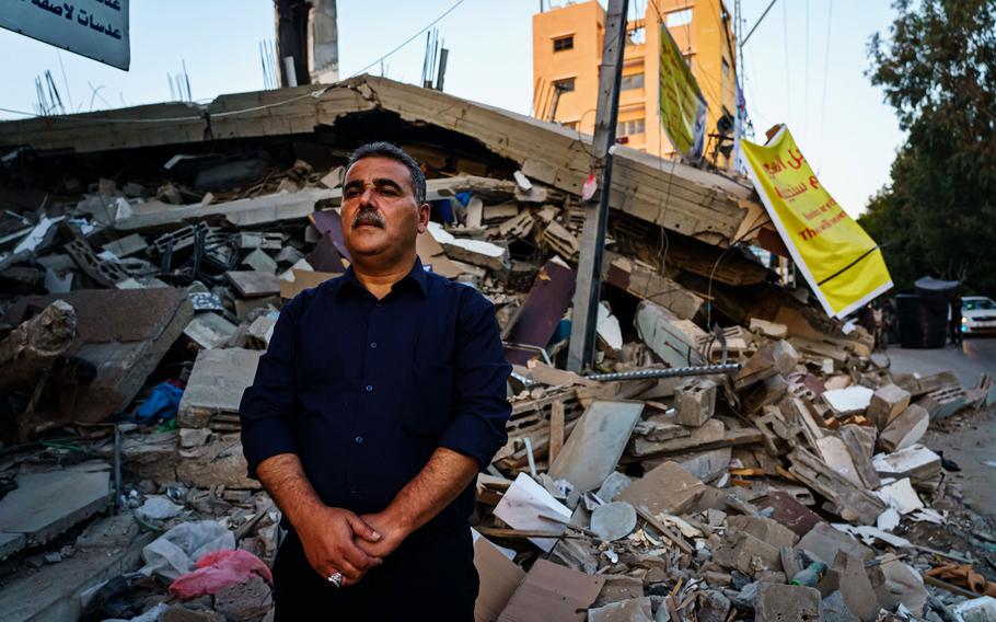 Samir Mansour stands before the remains of his bookstore in Gaza City on Wednesday, May 26, 2021. The bookstore, a Gaza cultural lodestar, was destroyed in an Israeli bombardment during the last escalation, which lasted 11 days between Israel and Gaza military factions.