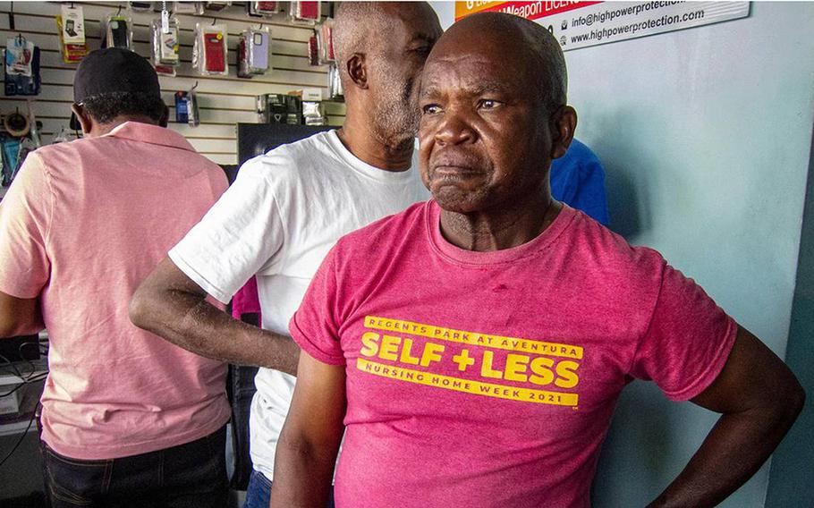 Eliantes Jean Jacques, who lost two family members to gang violence in Port-au-Prince, Haiti, speaks with a reporter inside a store in North Miami.