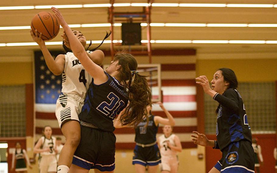 AFNORTH's Selah Skariah shoots a driving layup over Brussels' Patricia Rullan during a DODEA-Europe Division III basketball semifinals game Friday, Feb. 17, 2023, in Baumholder, Germany.
