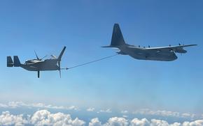 U.S. Marine Corps KC-130J Super Hercules with Marine Aerial Refueler Transport Squadron 152, Marine Aircraft Group 12, 1st Marine Aircraft Wing, refuels an MV-22 Osprey with Marine Medium Tiltrotor Squadron 268 Reinforced, Aviation Combat Element, Marine Rotational Force-Darwin 22, over the Pacific Ocean during a Trans-Pacific flight, Sept. 15, 2022. 