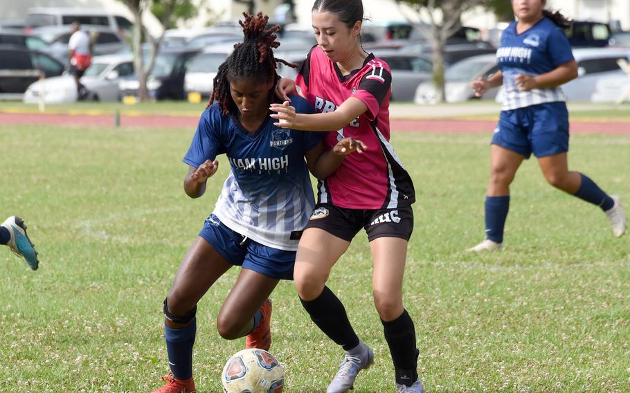 Guam High's NyKale Penn battles Kadena's Yumi Catlett for the ball during Tuesday's Division I girls soccer semifinal. Penn, formerly of Kadena, scored the lone goal of the match in the second overtime.