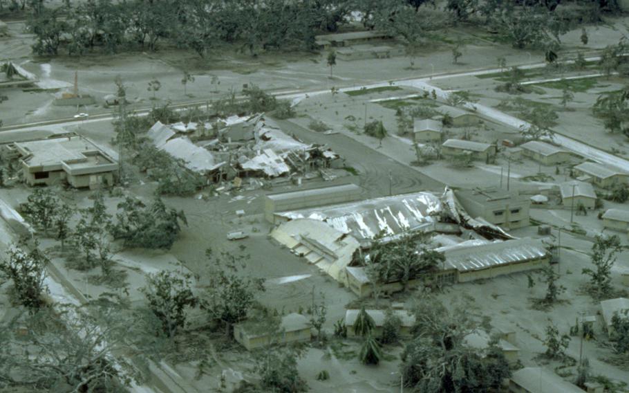 The roofs of hangars at Clark Air Base, Philippines, are collapsed under the weight of rain-saturated ash nine days after Mount Pinatubo's eruption on June 15, 1991.