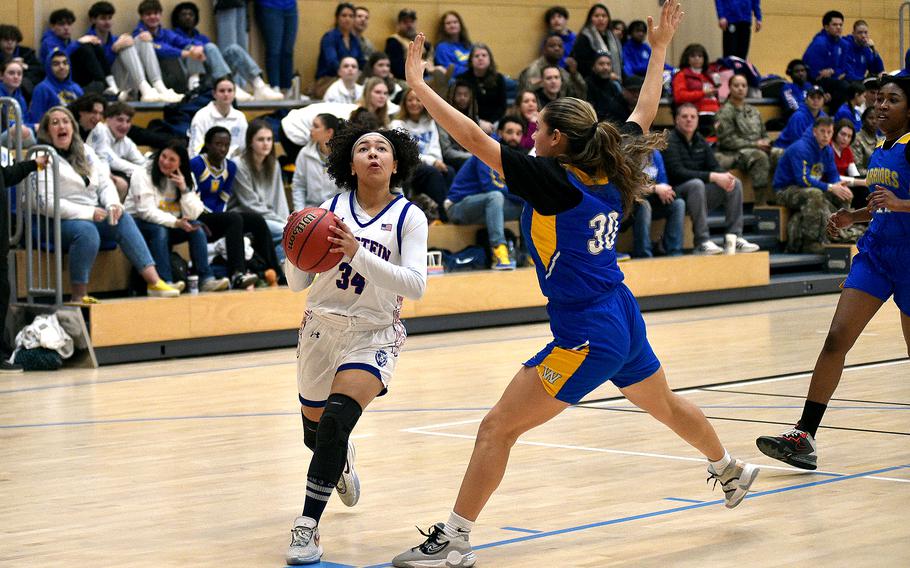 Ramstein sophomore Sanai Schneider drives to the bucket as Wiesbaden junior Natalia Bergdorf defends during pool-play action of the DODEA European basketball championships on Feb. 14, 2024, at the Wiesbaden Sports and Fitness Center on Clay Kaserne in Wiesbaden, Germany.