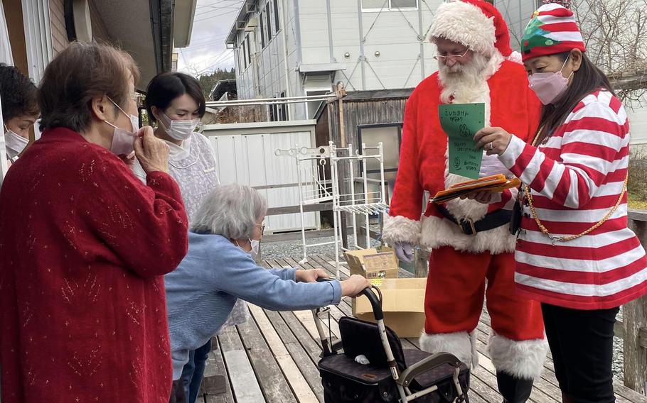 Navy veteran Ervin Lawrence and his wife, Rika, deliver gifts to the elderly in northeastern Japan during a Santa Delivery stop on Dec. 6, 2022. 