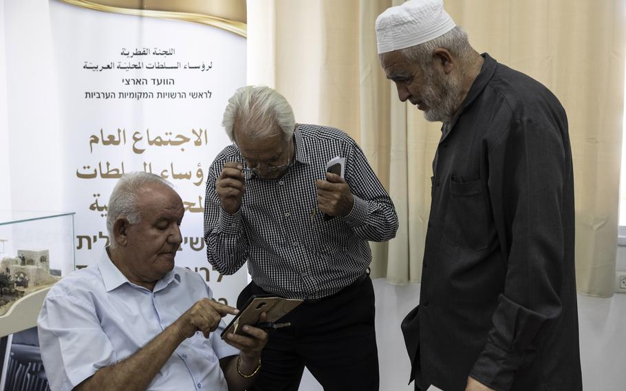 Raed Salah, right, speaks with members of the Higher Arab Monitoring Committee at a meeting in Nazareth on Nov. 9, 2023.