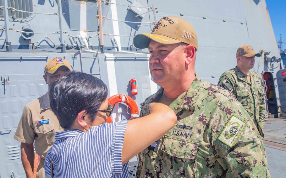 Cmdr. Cameron Dennis, then commanding officer of the Arleigh Burke-class, guided-missile destroyer USS Howard, receives his Command-At-Sea pin during a change-of-command ceremony in Yokosuka, Japan, on Sept. 1, 2023. 