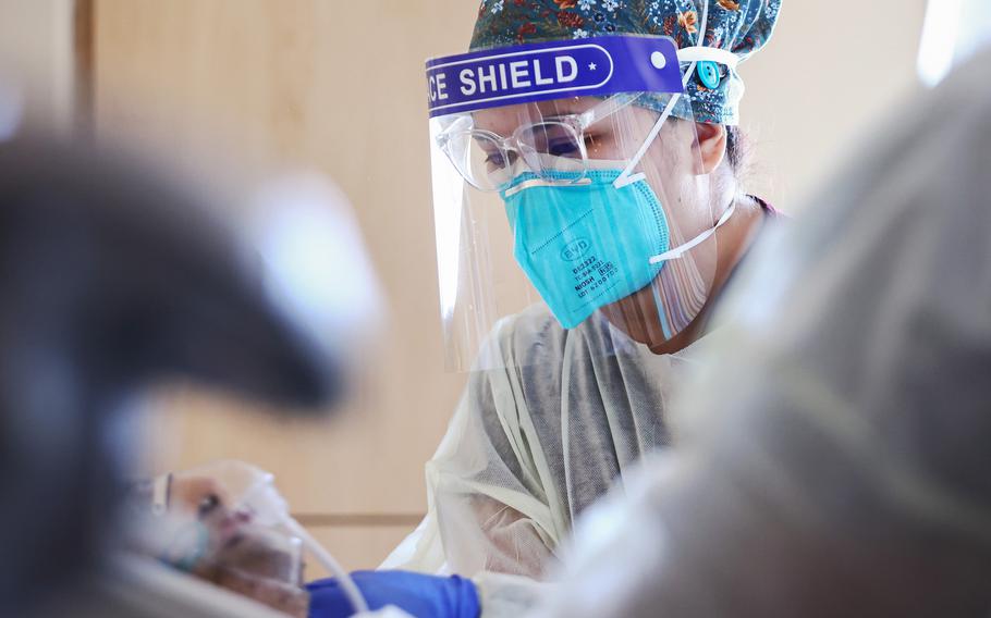 Registered nurse Elle Lauron cares for a COVID-19 patient in the COVID-19 unit at Providence Holy Cross Medical Center in the Mission Hills neighborhood on July 30, 2021 in Los Angeles, California. 