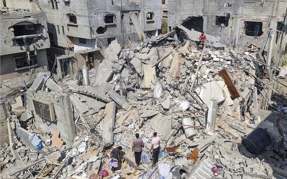 Palestinians survey the destruction after an Israeli airstrike in Rafah, Gaza Strip. on April 29, 2024.