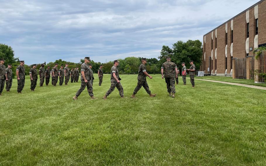 Marines with the Marine Advisor Company A, Force Headquarters Group, take part in a military awards ceremony at Joint Base Anacostia-Bolling in Washington, D.C., May 7, 2023. One of the four Marines being recognized thwarted a transnational criminal human trafficking organization while drilling with his unit that weekend.