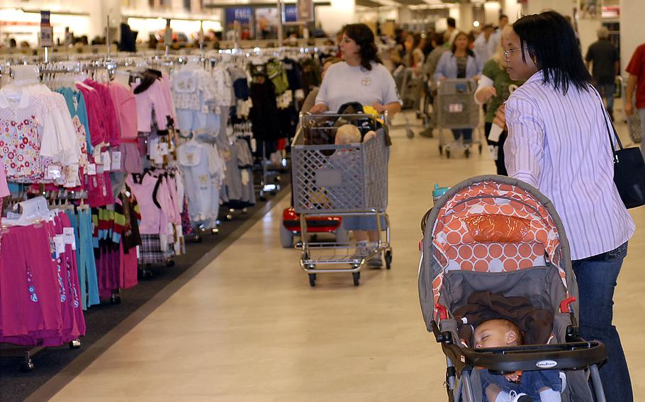 People shop at the Kaiserslautern Military Community Center's base exchange at Ramstein Air Base, Germany.  Following the 9/11 attacks, the U.S. military invested heavily in improving amenities in Europe. Bases became mini-Americas with shopping centers and more fast-food restaurants.