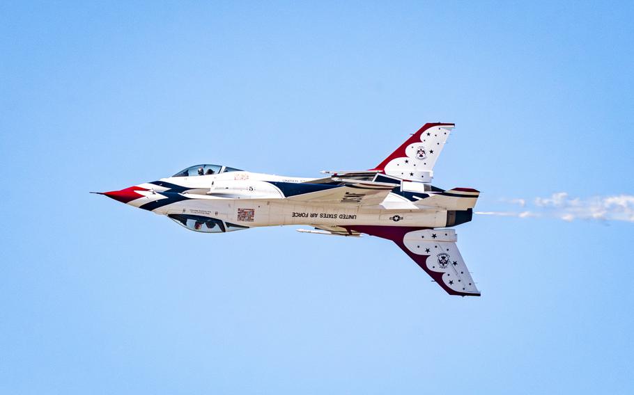 Two U.S. Air Force Thunderbirds perform a maneuver in the air